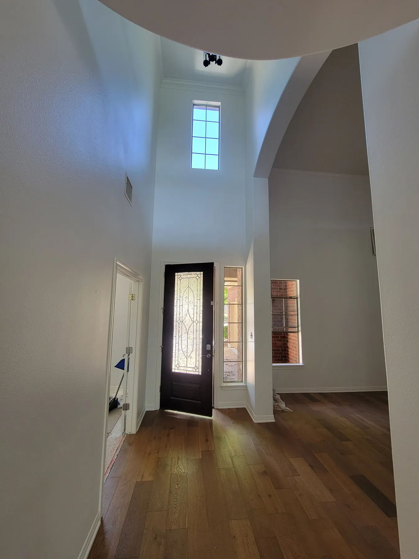 Tall Austin entry foyer with high painted walls, ceiling, and front door