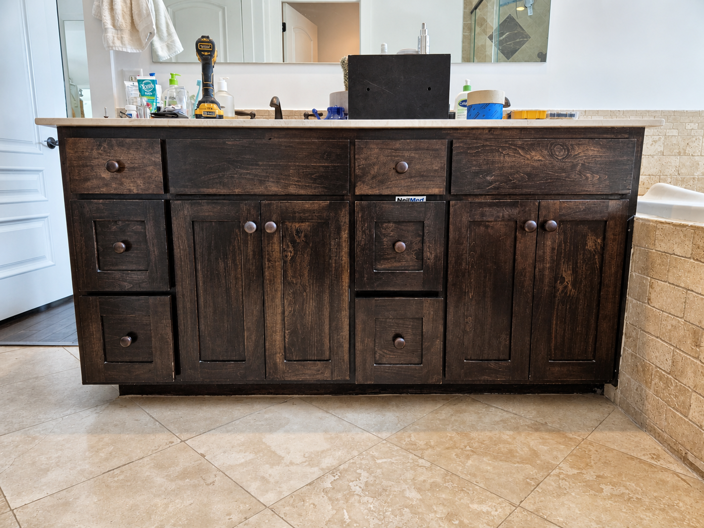 Dark stained bathroom vanity before cabinet painting