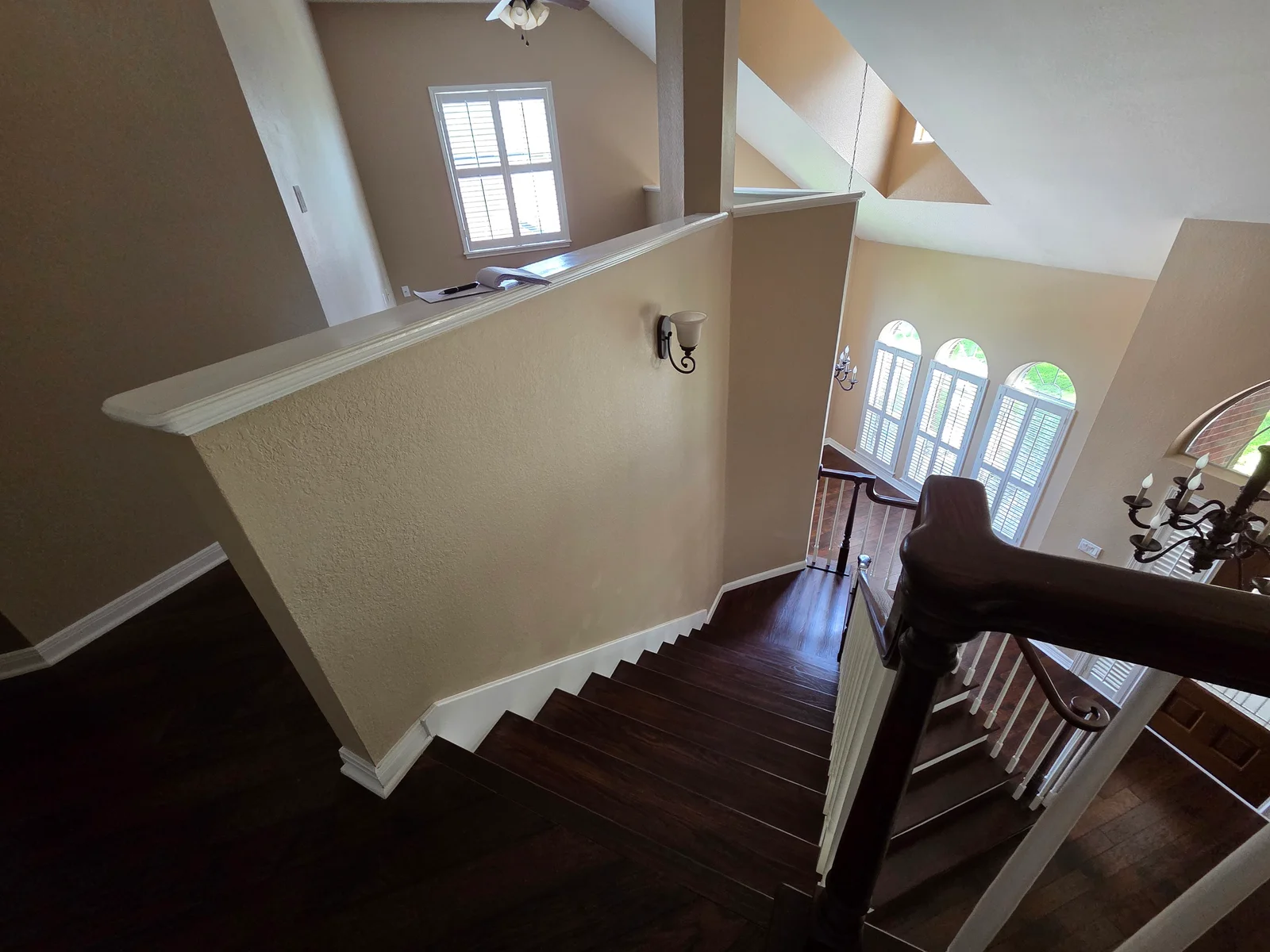 Round Rock staircase and tall walls before repainting from a darker color