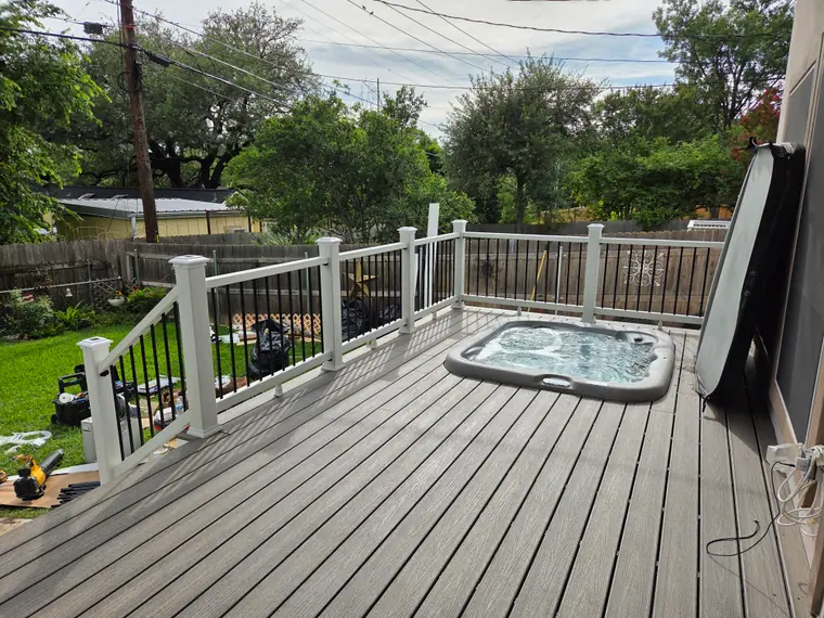 Updated residential deck with railing and outdoor spa in the Austin area
