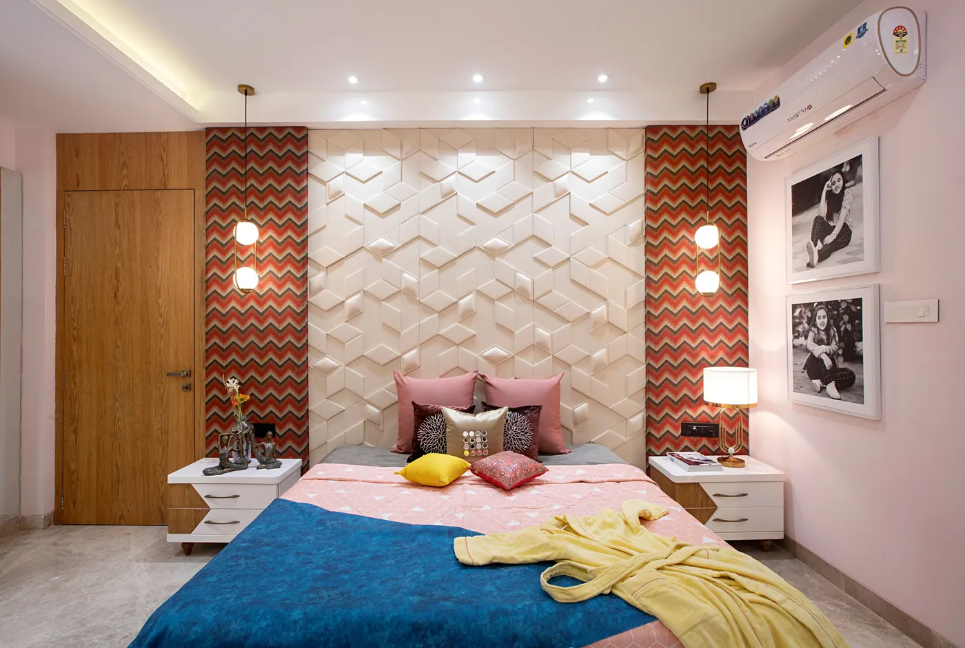 Bedroom with layered geometric accent wall panels behind the bed