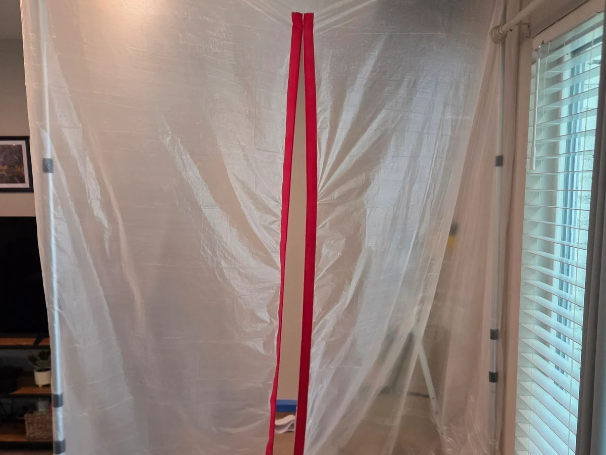 Interior room protected with plastic sheeting during drywall repair work