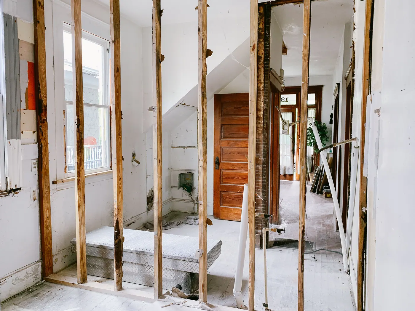 Interior home renovation with framing exposed and materials staged for repairs