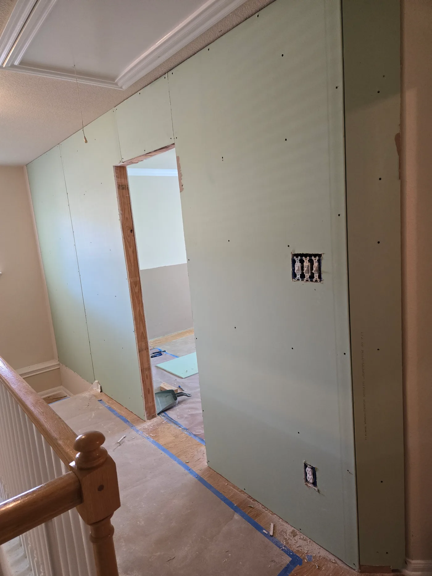 New drywall installed around an interior doorway during a home renovation